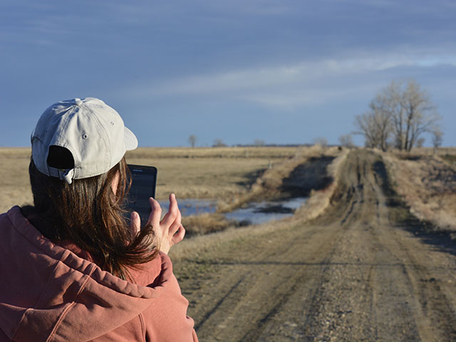 Farmers on a country road may not be able to summon an Uber driver from the app, but they can use the Uber system as a framework to think about their own profitability -- or lack thereof. (DTN photo by Elaine Kub)