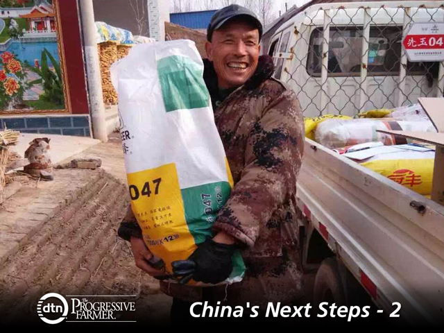 A Chinese grower displays his seed corn choice in a village of Shandong province. Pioneer is one of the multinationals having success marketing inputs. (Photo courtesy of DuPont Pioneer) 