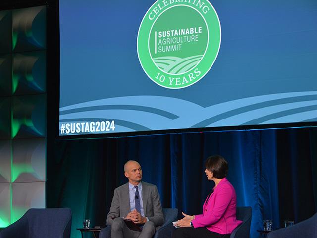 Rod Snyder, a former agricultural adviser to EPA in the Biden administration, talks with Carrie Vollmer-Sanders, president of Field to Market, at the opening of the Sustainable Agriculture Summit on Wednesday in Minneapolis. Snyder expressed concerns about the incoming Trump administration pulling out of the Paris Climate Accords, but said private companies will continue to focus on agricultural emissions. (DTN photo by Chris Clayton) 