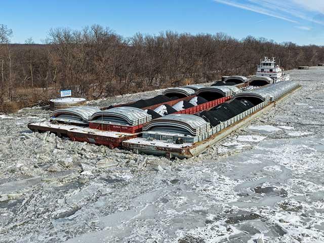 Ice on the Illinois River has been a problem for weeks. Barges have been unable to move, stuck in the ice. Pictured is a tow with barges recently stuck in the Marseille Canal. As of Feb. 4, four locks on the Illinois River have significant impacts caused by ice, according to the USACE Inland Waterway report. (Photo courtesy of the American Commercial Barge Line)