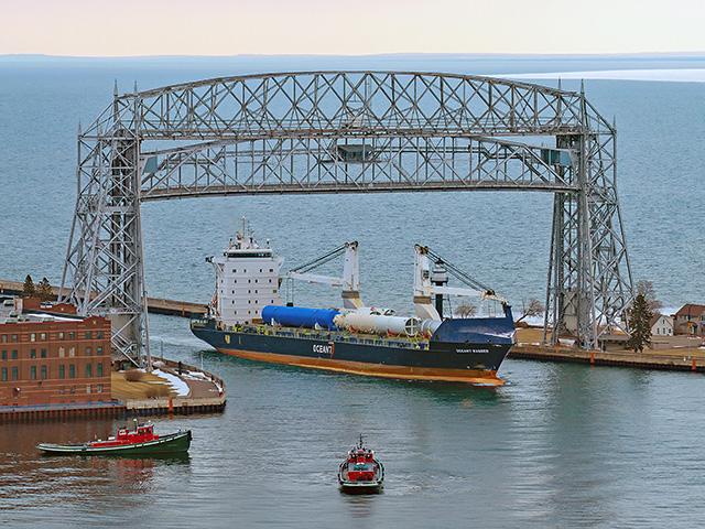 The first ocean vessel of the season, saltie Motor Vessel Ocean7 Ranger, arrived under the Duluth, Minnesota, lift bridge on April 8, accompanied by tugs North Carolina and Missouri. (Photo courtesy of Schauer Photo Images)