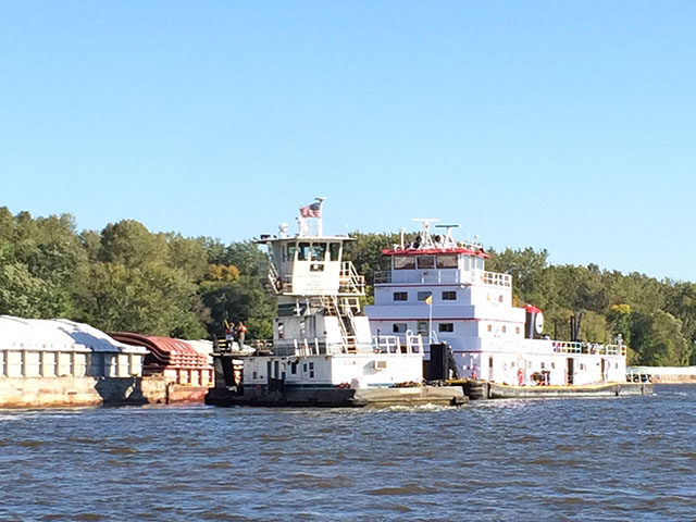 Tug boats hook up with empty barges on the Mississippi River east of downtown St. Paul, Minnesota. (DTN photo by Mary Kennedy)