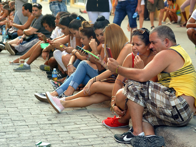 Cubans hang out on a Sunday afternoon at an internet hotspot in Old Havana. (Photo by Jim Patrico)