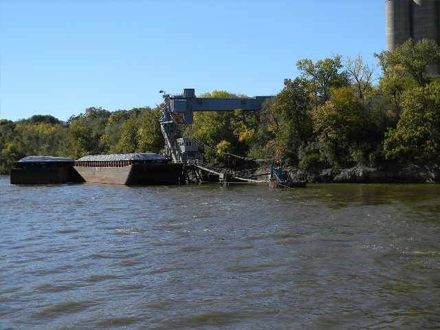 Barges waiting to be loaded with new crop sit in front of a river terminal in the Upper Mississippi River. River conditions heading south to the Gulf are still not ideal for the harvest rush of corn and especially soybeans to the Gulf. (DTN photo by Mary Kennedy)