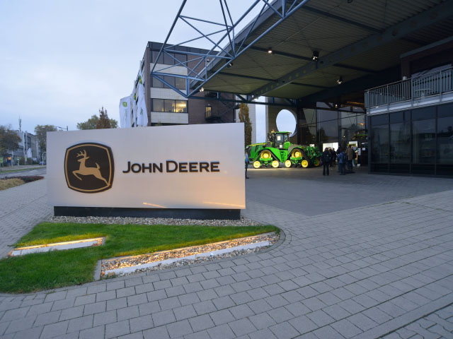 About 25,000 visitors annually stop at John Deere&#039;s tractor factory in Mannheim, Germany. The plant makes several versions of the 6 Series tractors, some of which are exported to North America. The 9RX in the background is for display only and came from the U.S. factory in Waterloo, Iowa. (DTN/The Progressive Farmer photo by Jim Patrico)