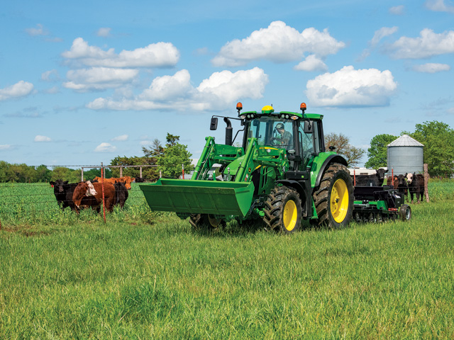 John Deere offers a handful of factory-installed technology options on its 6Ms, including StarFire 6000, AutoTrac and JDLink. Here, Deere&#039;s 6120M tractor is matched with the 600R loader. (Photo courtesy of John Deere)