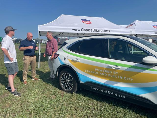 Geoff Cooper, center, president and CEO of the Renewable Fuels Association, talked to farmers at the Farm Progress Show last month with RFA&#039;s flex-fuel/electric hybrid Ford Escape that RFA modified to run on E85 fuel. RFA and other groups continue to be locked in a battle with EPA&#039;s Science Advisory Board about studies used to validate corn ethanol&#039;s greenhouse gas reductions compared to gasoline. (Photo courtesy of RFA)