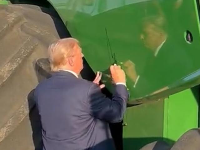 Former President Donald Trump signs a John Deere combine on Sunday on a farm in south-central Iowa after holding a rally in Ottumwa, Iowa. Trump touted his record with farmers and criticized current President Joe Biden as well as GOP rivals. (Image from X, formerly known as Twitter) 