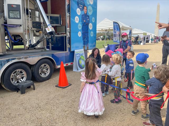 Stephanie Dillon, advisory specialist with DeLaval, answers milking questions from a group of local preschoolers during National Ag Day. DeLaval was one of 30 companies and organizations who participated in the Celebration of Agriculture on the National Mall in Washington, D.C., during Ag Day, March 22. (DTN photo by Greg Horstmeier)
