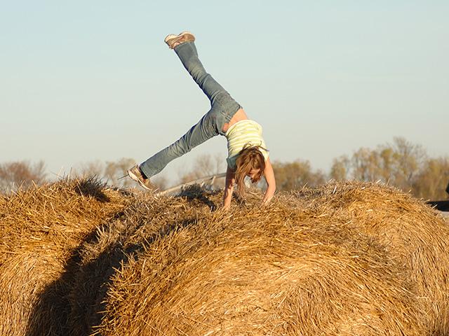 A farm is a great place to raise children, as nearly everything, including hay bales, is a playground. However, there are many hazards that farm kids face. (DTN/Progressive Farmer file photo by Jim Patrico)