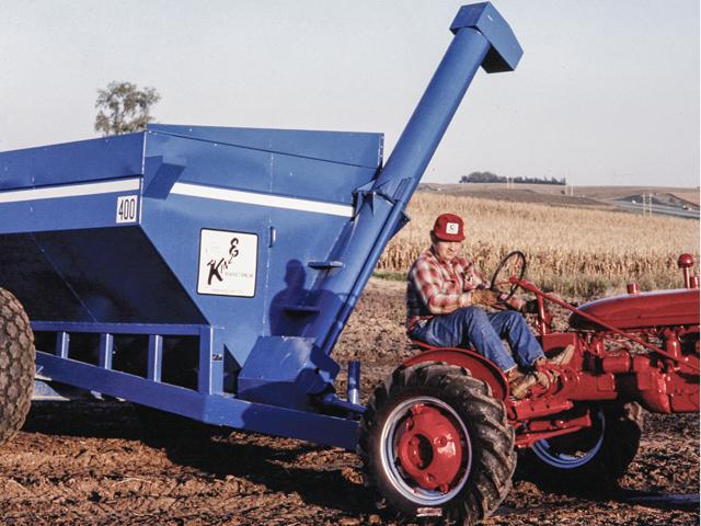 Kinze founder Jon Kinzenbaw pulls Kinze&#039;s first grain cart, the 400 model, in this photo from the 1970s. (DTN photo courtesy of Kinze Manufacturing)