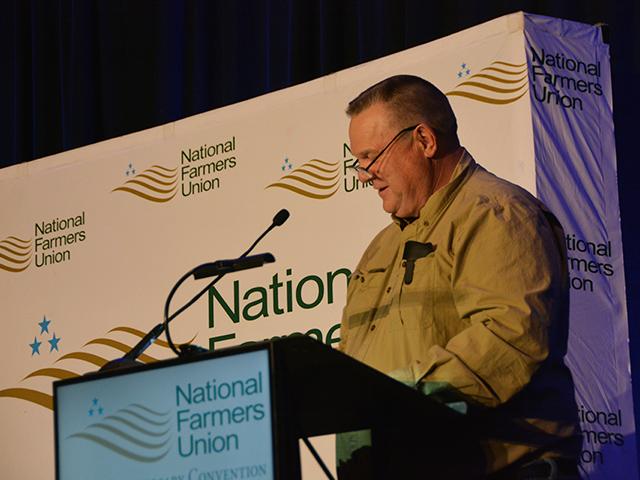Sen. Jon Tester, D-Mont., speaks Sunday at the 120th National Farmers Union annual meeting in Denver. Tester said the Senate could take up two bills dealing with cattle markets and meatpackers, including one that would mandate more regional negotiated cash trade. (DTN photo by Chris Clayton) 
