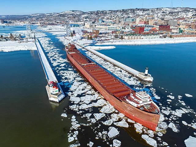 The Lee A. Tregurtha was the first ship of the 2023 navigation season to pass under the aerial bridge and through the Port of Duluth canal, coming out of hibernation after it wintered in Duluth-Superior. (Photo courtesy of Schauer Photo Images)