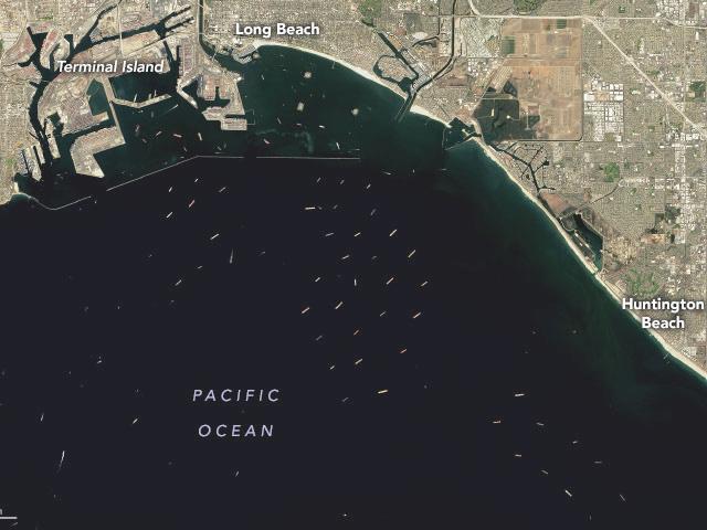According to the Marine Exchange of Southern California, 111 container ships were in the port on Nov. 9, a new high. Of those, 30 were at the Los Angeles/Long Beach berths, 32 at anchor and a record 49 "loitering" (in holding patterns), reported American Shipper. (Satellite photo taken Oct. 10 by NASA Earth Observatory)