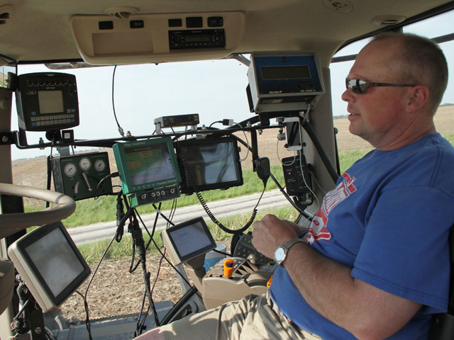 Modern technology and a work ethic allowed growers like Dean Werries to push corn planting to another level last week. The Chapin, Ill., grower sits surrounded by monitors. (DTN photo by Pamela Smith)