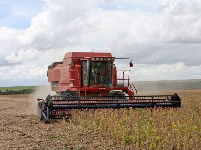 Combines moving through Brazil soybean and corn fields will get fuller much faster than a year ago, according to the latest CONAB estimates. (DTN file photo by Alastair Stewart) 