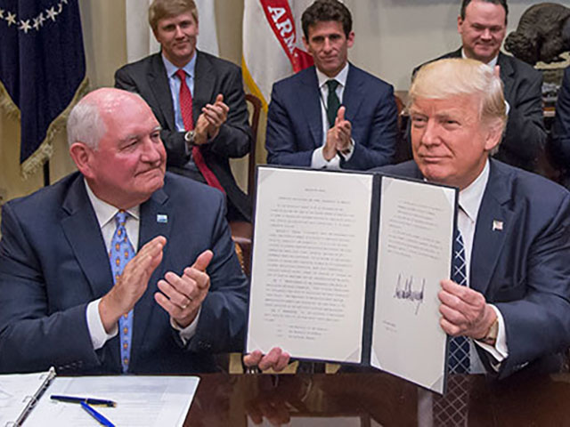 Agriculture Secretary Sonny Perdue applauds as President Donald Trump after signed an executive order Tuesday supporting regulatory relief for farmers and rural economic development. Yet farm groups are worried the president may be trying to pull the U.S. out of NAFTA. 