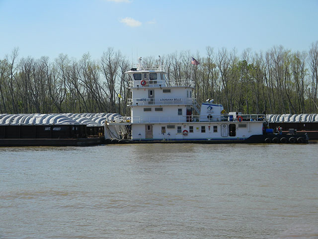 The Louisiana Belle and her crew busy parking barges along the Mississippi River near Destrehan, Louisiana, in late March. As flood waters move down river this week, barge traffic will be slow, or in some areas, stopped. (Photo by Mary Kennedy)