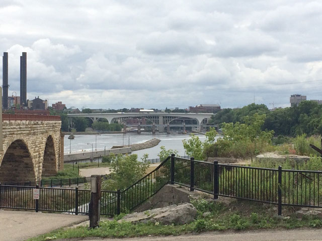 Pictured in the background of this photo is the rebuilt I-35W bridge, now known as the I-35W St. Anthony Falls Bridge that spans the Mississippi River in downtown Minneapolis, Minnesota. The original bridge collapsed 10 years ago on Aug. 1, 2007, sending the center of the channel span over 100 feet into the Mississippi River below, killing 13 people and injuring 145 others. It is a miracle that so many of those people who had been on the bridge when it collapsed survived that fall. (DTN photo by Mary Kennedy)