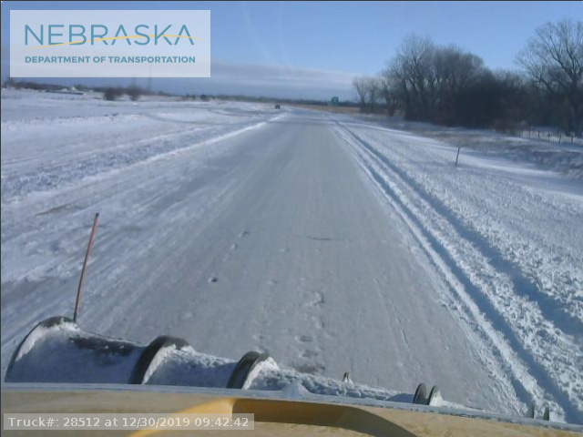 Snowplow action on Interstate 80 near Grand Island, Nebraska is an example of slowdowns and stoppages to travel and transportation caused by the big central U.S. storm during the final weekend of 2019. (Nebraska Road Department photo)