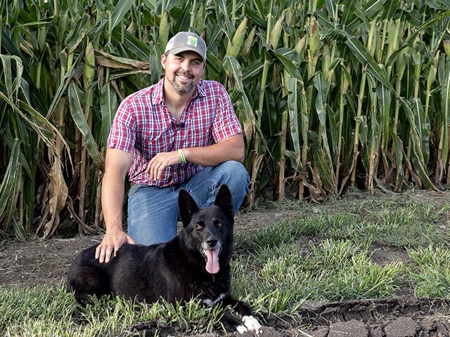 Checking crops after plentiful rainfall in August has Zachary Grossman (and his dog, Sadie) anticipating a better harvest than was expected earlier in the season. (DTN photo by Jason Jenkins)