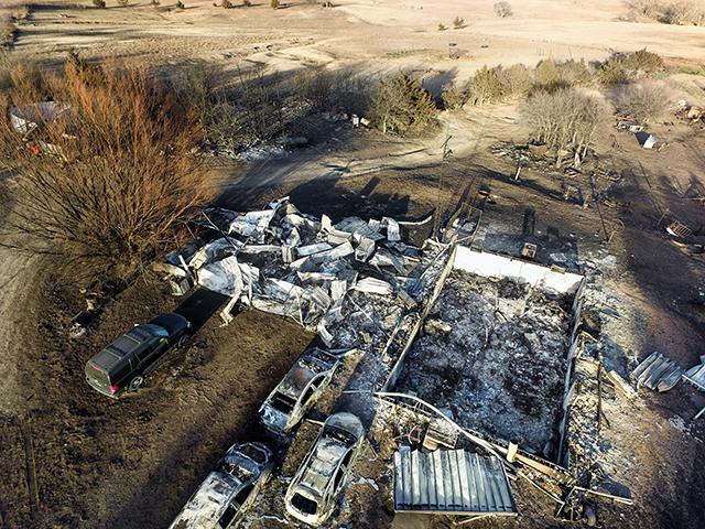 While hiding beneath an old feed truck, Jim Rathbun watched his Kansas farmhouse burn to rubble. (Larry Reichenberger)