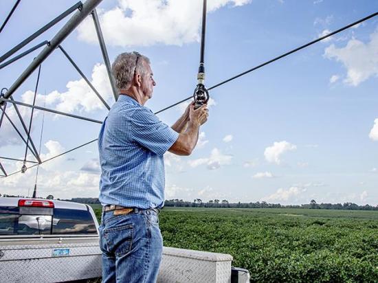 A Georgia farmer retrofits his sprinklers with support of EQIP funding. The Senate farm bill discussion draft reduces EQIP funding between FY2027 and FY2030 before restoring higher baseline funding in FY2031. (Progressive Farmer photo by Mark Wallheiser)