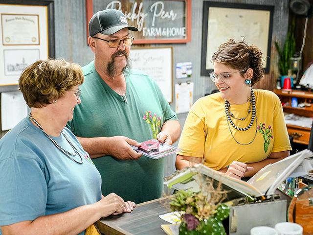 Ellie Bowman, right, with the help of her parents, left, transformed a Kansas lumberyard into thriving Prickly Pear Farm and Home by listening to customers and providing excellent service. (Courtesy of Prickly Pear Farm and Home)