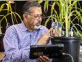 Raj Khosla, head of agronomy at Kansas State University, inspects a prototype soil sensor in a lab at the university. (DTN/Progressive Farmer photo by Joel Reichenberger)