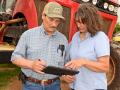 Karen Eifert Jones and husband, Rodney, consult field records before heading to the field to spray. (Progressive Farmer image by Larry Reichenberger)