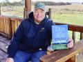 Gabe Brown poses with his book "Dirt to Soil." (Des Keller)
