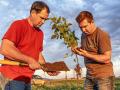 Payments through the carbon intensity system could encourage more farmers like Brian (left) and Mitchell Hora to grow low-carbon crops. (Gil Gullickson)