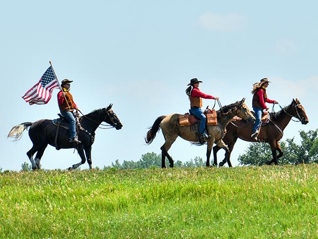 The National Pony Express Association&#039;s re-ride honor guard arrives in Elwood, Kansas, at the first stop of a nearly 2,000-mile reenactment. (Jim Patrico)
