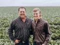 The late Timothy Pohlmann (left) and his son Clay Pohlmann stand in front of the family's soybean field. Tim passed away on Oct. 31, 2021, at the age of 46. (Courtesy photo)