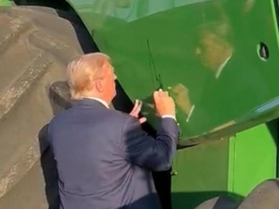 President Donald Trump signs a combine at a farm event in Iowa in 2024. The White House on Wednesday requested another $11.1 billion ad-hoc aid package for farmers, of which $10 billion would go to row-crop and specialty crop farmers. Trump also is holding a dinner at the White House on Thursday with farmers from around the country. (DTN file photo)  