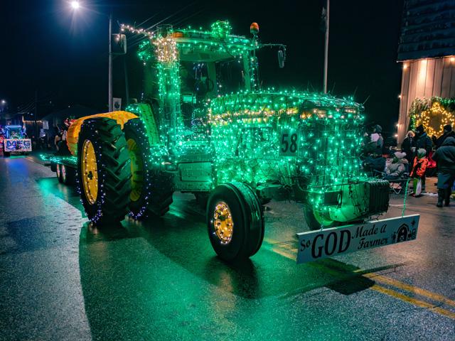 Chad Loucks rolls through downtown Linesville, Pennsylvania, in his elaborately lit John Deere 8100 tractor during the 11th annual Linesville Tractor Parade. The event attracts nearly 100 Christmas-light-decorated tractors ranging from field machines to lawn mowers. (DTN photo by Joel Reichenberger)