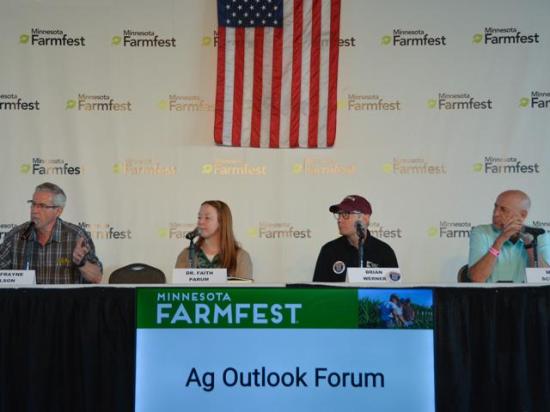 At Farmfest in Minnesota, Frayne Olson, left, a crops economist at North Dakota State University Extension, talks about pressures facing farmers to finance their operations this year and challenges they could face with next year's crop. Also on the panel were Faith Parum from the American Farm Bureau Federation, Brian Werner, executive director of Minnesota Biofuels, and Mark Schultz, a market analyst with North Star Commodities. (DTN photo by Chris Clayton) 