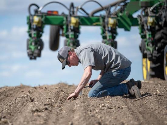 Tyler Rath of Belgrade, Minnesota, checks seeding depth on corn being planted in an organic production system. Rath is one of the farmers providing insights about the 2026 crop season as part of DTN's View From the Cab series. (DTN photo by Joel Reichenberger)