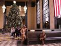 Christmastime at The Durham Museum in Omaha includes a giant Christmas tree newly donated and decorated each year. Bronze statues help capture the history of the former train station and symbolize people who once traveled through Union Station, from businesspeople to soldiers. (DTN photo by Elaine Shein)