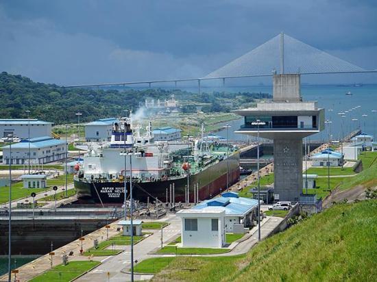 A Neopanamax ship passes through the Panama Canal&#039;s Agua Clara lock in 2019. This lock was a result of the Panama Canal Expansion in 2016 to allow the transit of larger ships. The Atlantic Bridge is seen in the background. (Photo courtesy of Wikipedia)