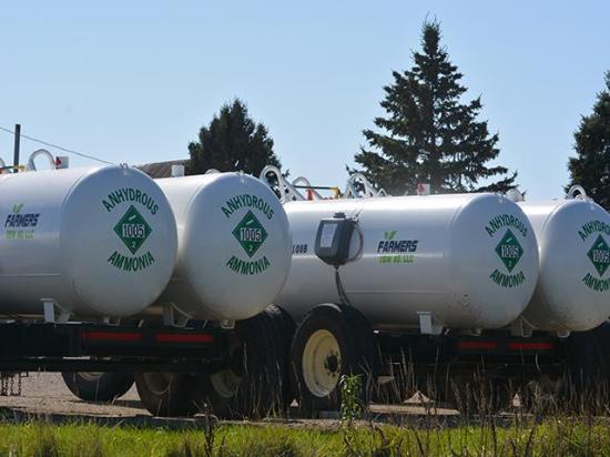 Anhydrous tanks outside a farmers' cooperative in Iowa. Farmers face higher fertilizer prices despite stagnant corn prices. The Iowa Corn Growers Association on Thursday encouraged the Justice Department to investigate the fertilizer industry after a Bloomberg report stated such as investigation is underway. (DTN file photo by Chris Clayton)