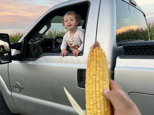 Let the crop scout training begin. Luke Garrabrant&#039;s daughter, Gracen, indicates her pleasure at the corn yield potential this year. This week DTN&#039;s View From the Cab talks about raising crops and kids on the farm. (Photo courtesy of Luke Garrabrant)