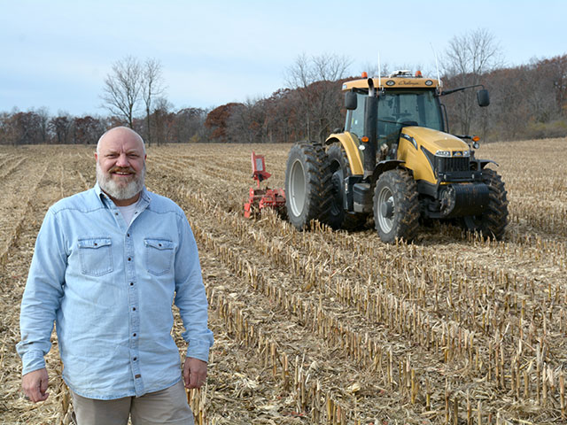 Craig Rupp, founder and CEO of Sabanto, is scaling up his robotic farming company by installing autonomous technology in tractors owned by farmers, such as this one tilling a recently harvested cornfield in southeast Wisconsin. (DTN photo by Matthew Wilde)