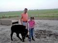 Emma Yerkey with her dad, Tim Yerkey, and a ribbon-winning calf they raised together. The family farms near Geneseo, Illinois. Tim Yerkey died by suicide in 2011. He had been struggling for about a year when spring floods left fields underwater. He had visited the emergency room seeking mental-health help, only to be told there were no beds, Yerkey said. (Photo courtesy of Emma Yerkey) 