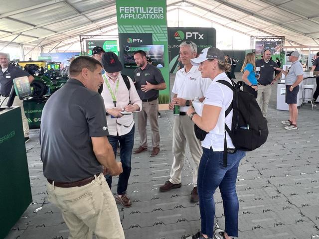 AGCO CEO Eric Hansotia (center, white shirt and khaki pants) tells Morgan Stanley audience members that the equipment manufacturer has already sold out its new autonomous grain cart and sprayer retrofits this year. (DTN photo by Dan Miller)