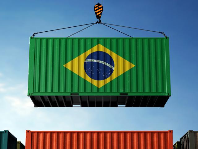 A shipping container displaying the Brazilian flag. Farmers are navigating currency fluctuations in Brazil, high interest rates, rising input costs and the reelection of President Luiz Inacio Lula da Silva. (Getty Image by Iskandar Zulkarnaen)