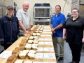 Bread baked from wheat grown by winners in the 2025 National Wheat Yield Contest was evaluated at the Great Plains Analytical Laboratory (GPAL) in Kansas City, Missouri. Pictured, from left, is Seadon Rolston, Brian Walker with the National Wheat Foundation, Todd Lowenstein and Lacey Schmidt. (Photo courtesy of Brian Walker)
