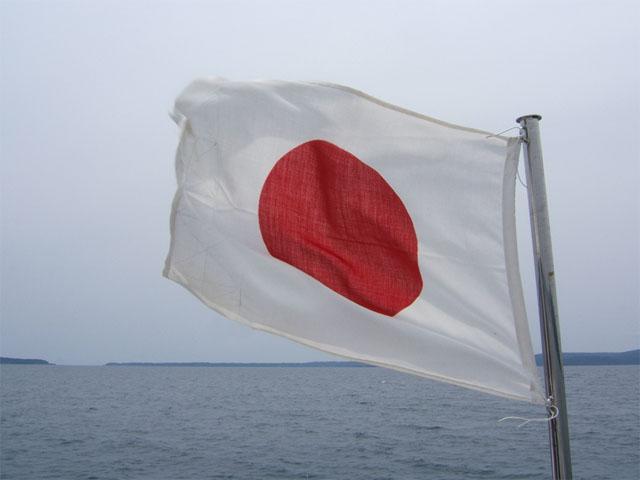 A Japanese flag blows in the wind. A group of more than 50 lawmakers have written the U.S. trade ambassador's office, asking the Trump administration to begin a second round of trade talks with Japan that would include greater dairy access to the country. (DTN file photo)  