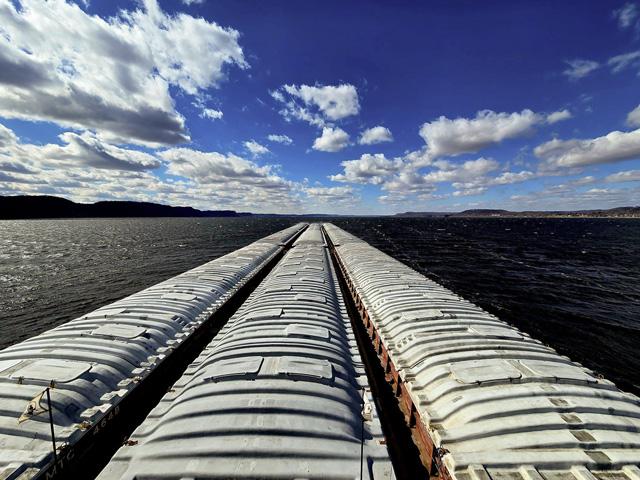 What a difference a year (and a warm winter) makes! Pictured is MV Joseph Patrick Eckstein pushing barges through Lake Pepin on a sunny day with no ice in sight. Two tows last year had to break their way through the ice on Pepin on their way to St. Paul, Minnesota. (Photo courtesy of Lee Klaproth)