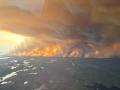 Flames and thick smoke from a wildfire near Flin Flon, Manitoba, Tuesday, May 27, 2025, exemplify this spring&#039;s harsh Canadian fire outbreak. (The Canadian Press/HO-Manitoba Government photo)